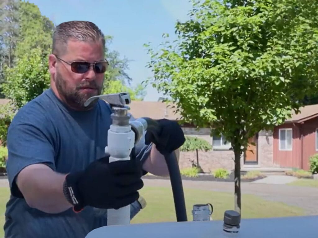 corrigan employee servicing a propane tank